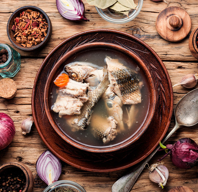 The key difference between a fish stew and chowder or curry 
  is the the sauce is thin and transparent, not thickened or creamy