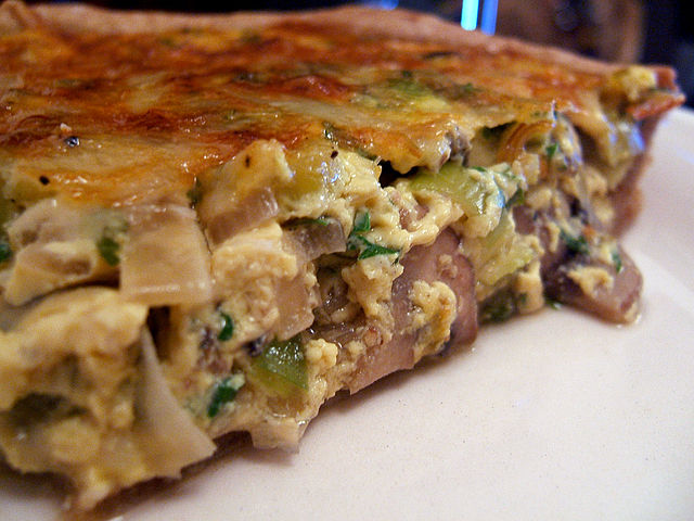 Seafood and fresh vegetables pair well in quiches topped with herbs and flavorsome cheeses